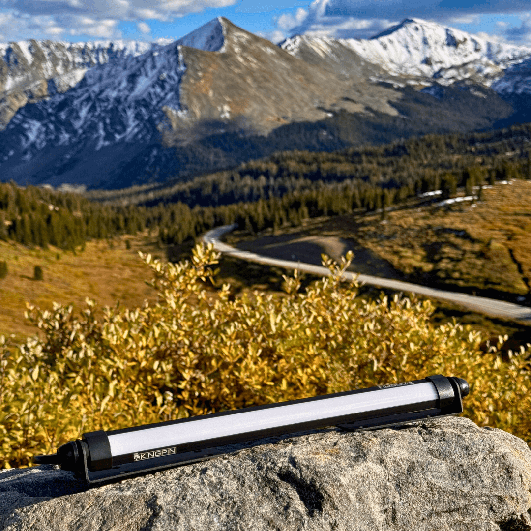 Kingpin V-Series 12" light on a rock with mountains behind it