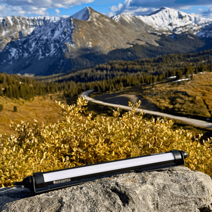 Kingpin V-Series 12" light on a rock with mountains behind it