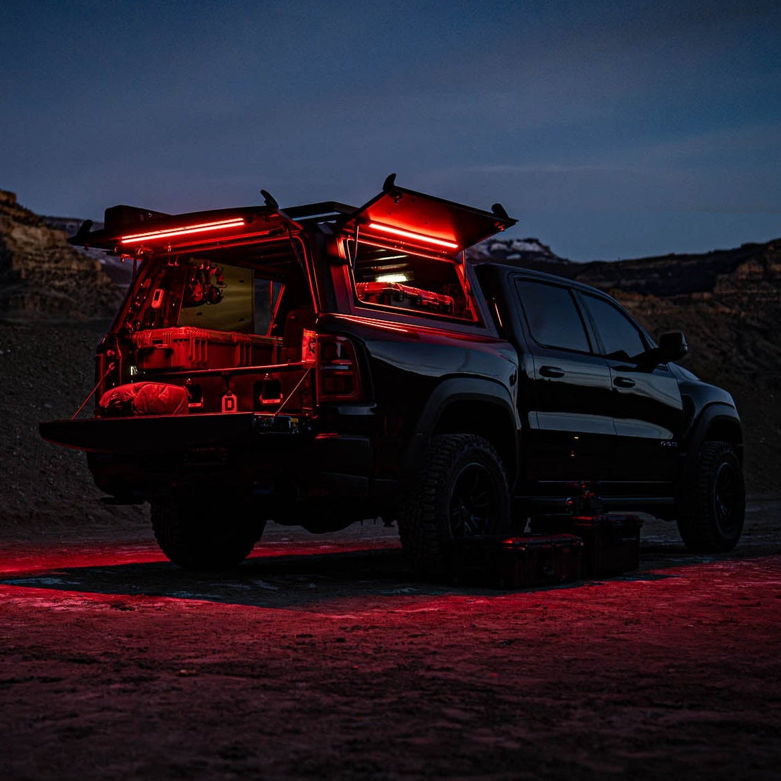 Pickup at night with its truck cap glowing red from Kingpin F-Series lights