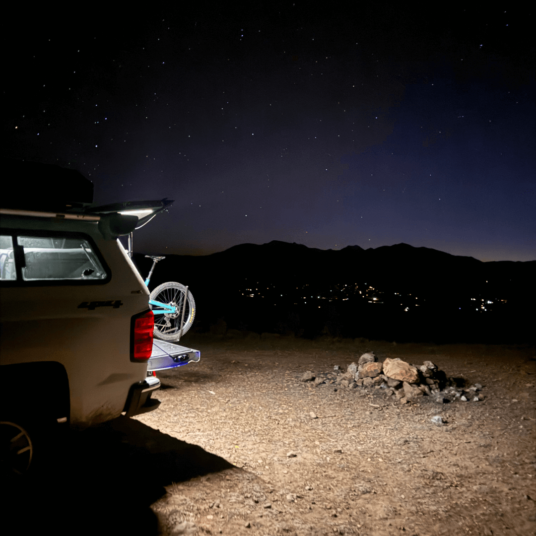 Truck cap at a night camp with a Kingpin light lighting the ground