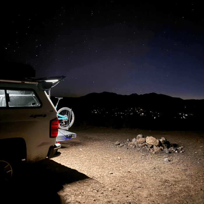 Truck cap at a night camp with a Kingpin light lighting the ground