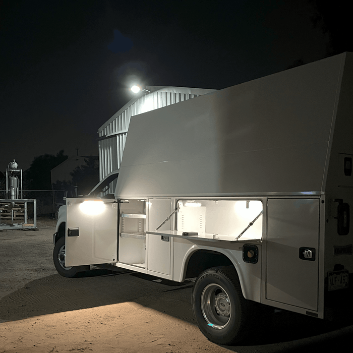 Utility work truck at night with side compartments lit by Kingpin lights