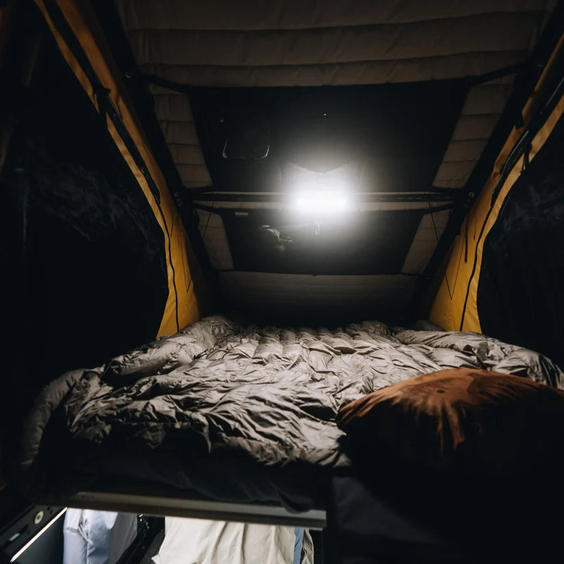 Rooftop tent bed lit by a Kingpin F-Series 12" light