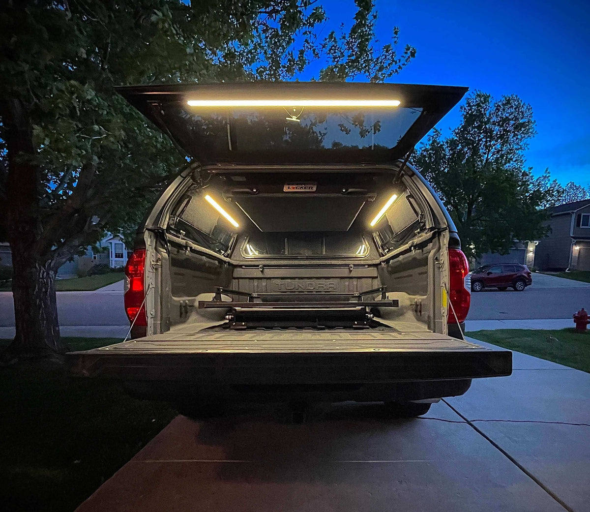 Truck cap with the tailgate down and the bed lit by Kingpin lights
