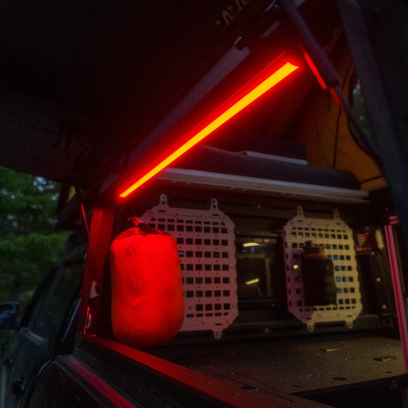 SUV cargo area at night lit red by a Kingpin F-Series light
