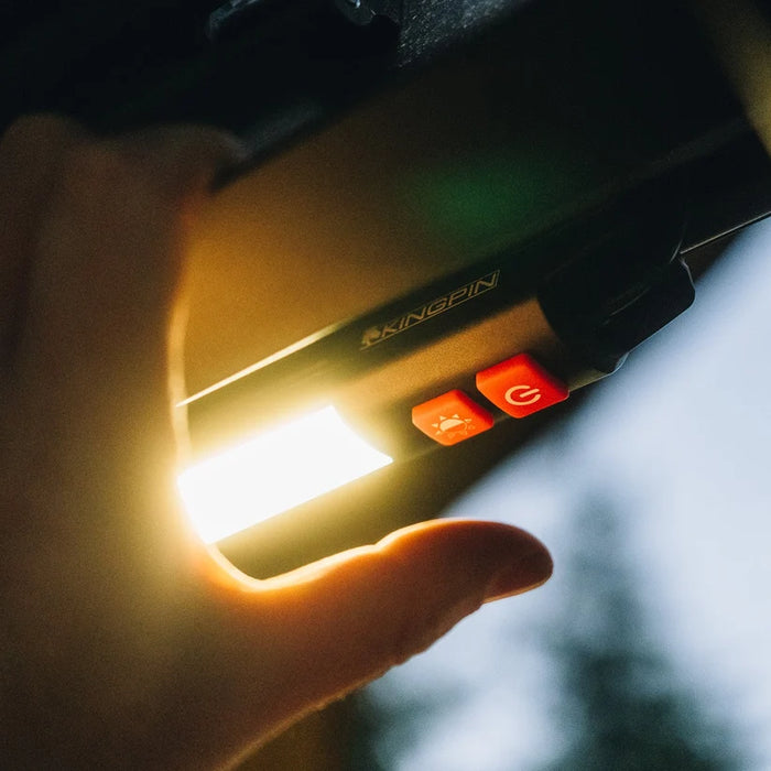 Hand pressing the button on a lit Kingpin F-Series 12" light