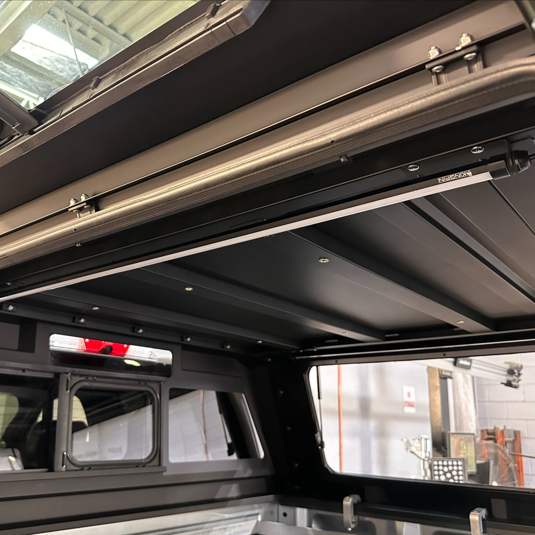 Lights in ceiling of smartcap truck canopy inside of a shop