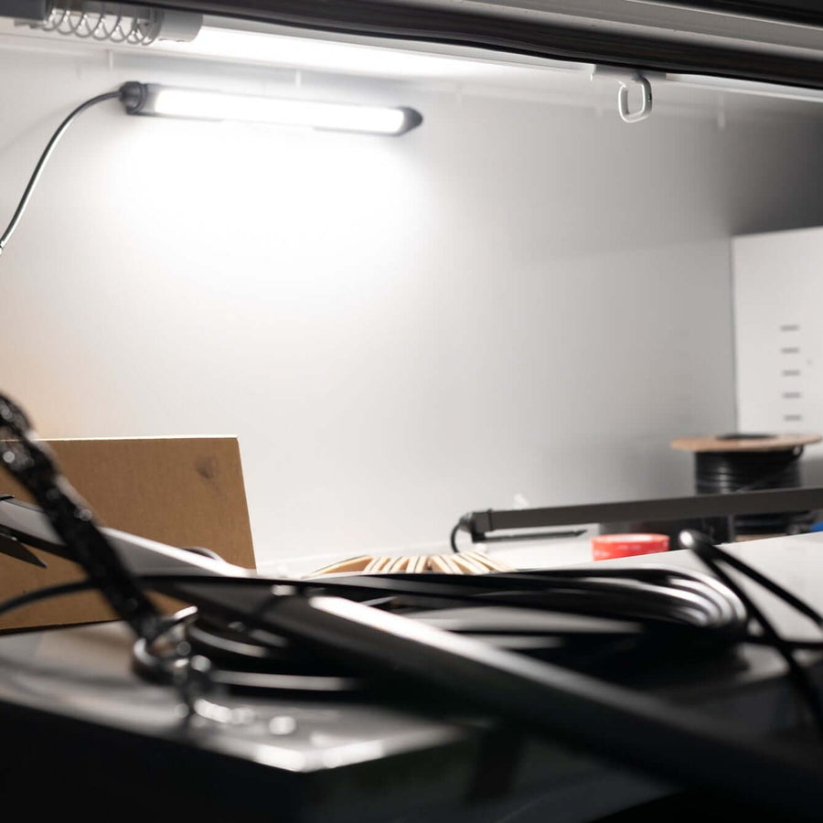 Kingpin V-Series 12" light lighting a work truck storage compartment