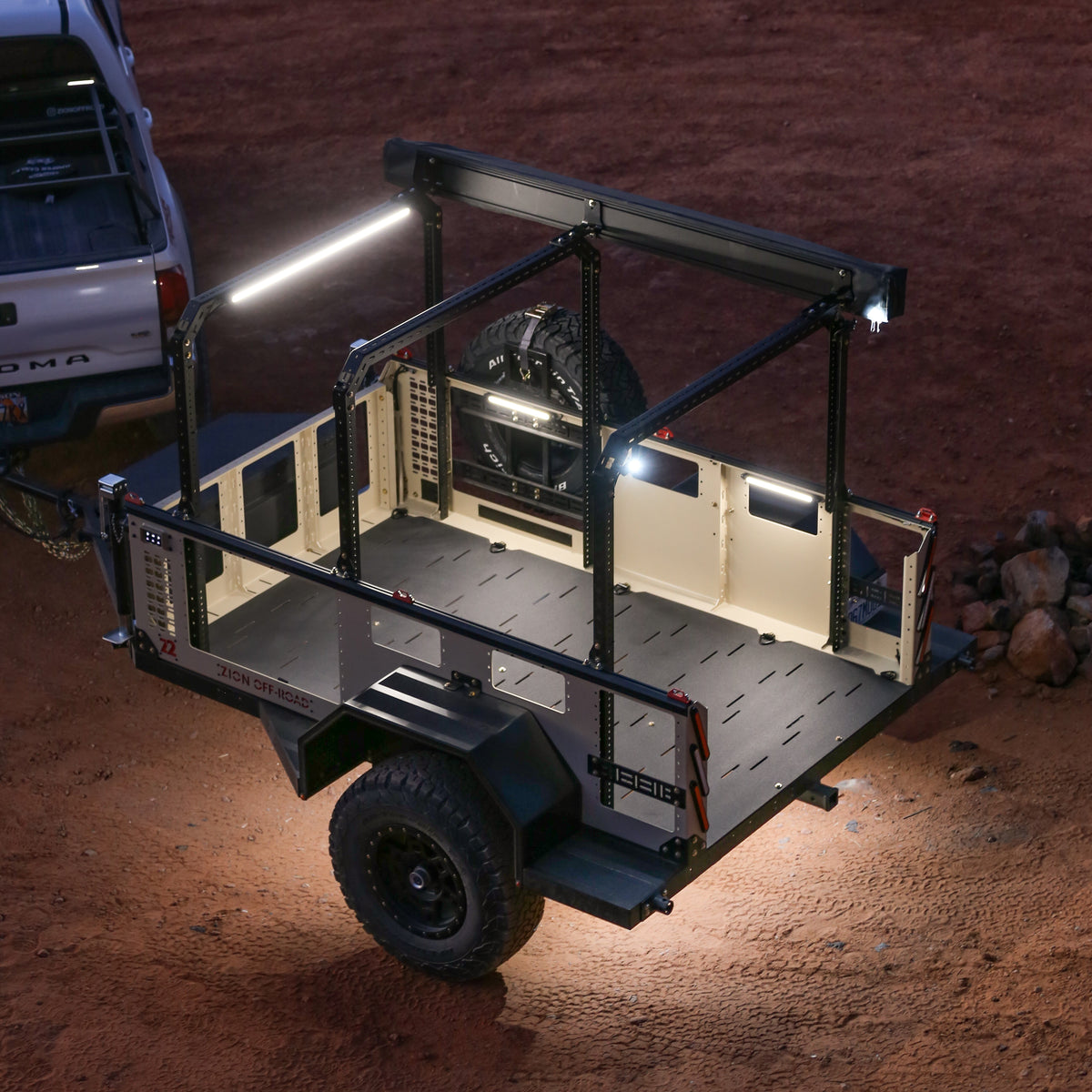 Small off-road trailer at night lit by Kingpin F-Series lights