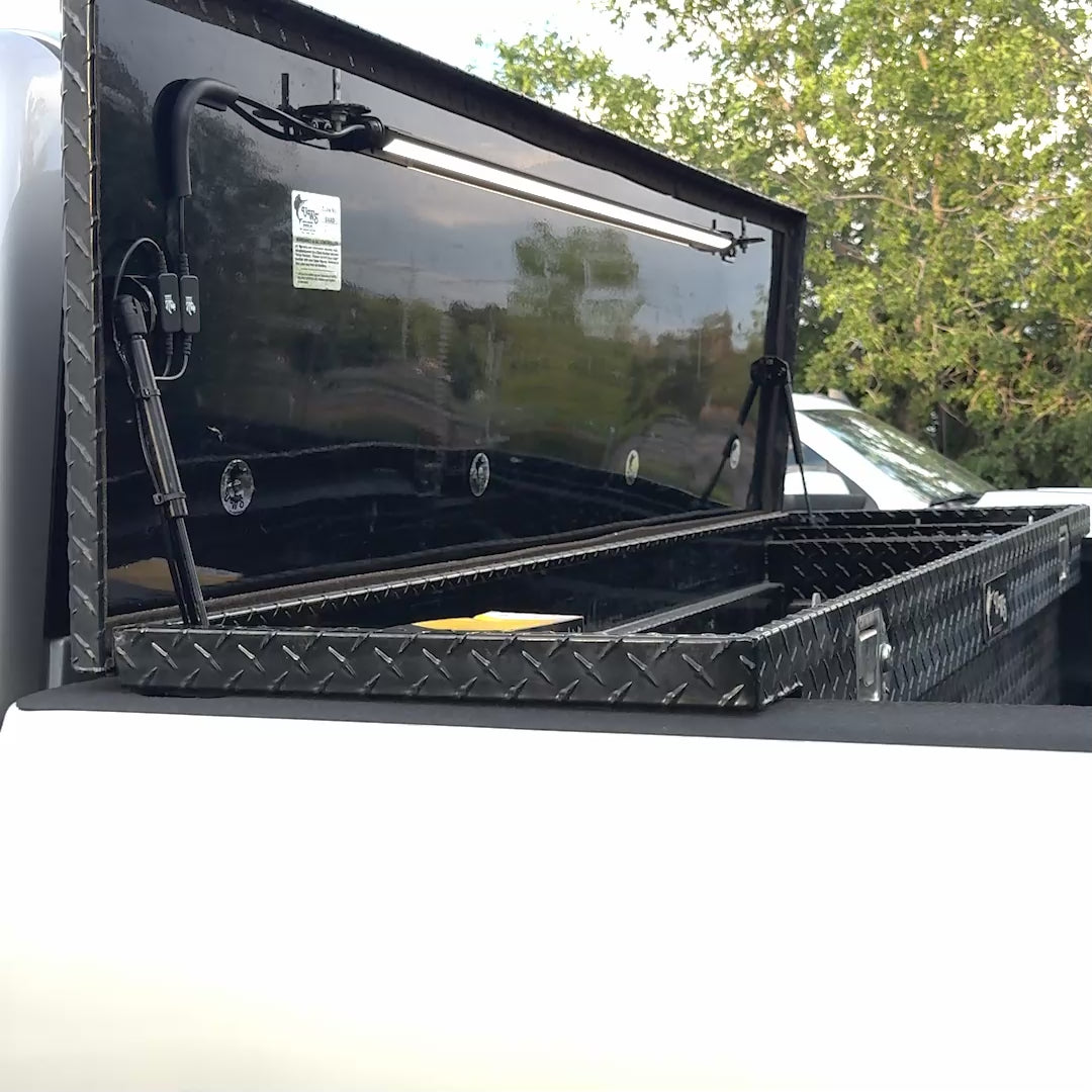 Kingpin light mounted inside an open truck toolbox lid